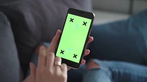 Female Hand Swiping and Flipping on Green Screen of Smartphone