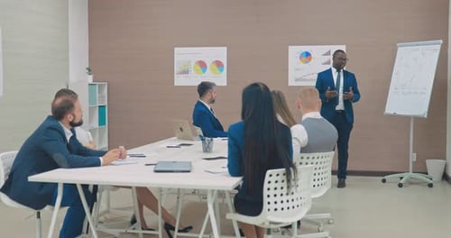 Office Presentation by Chart in Bright Workplace