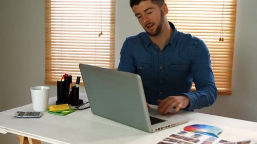 Male graphic designer using laptop