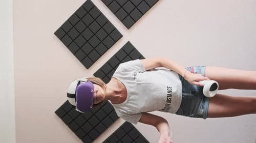 Woman Using VR Headset and Controllers Indoors