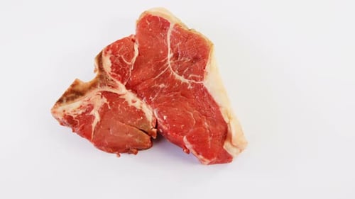 Raw T-Bone Steak Close Up on White Background
