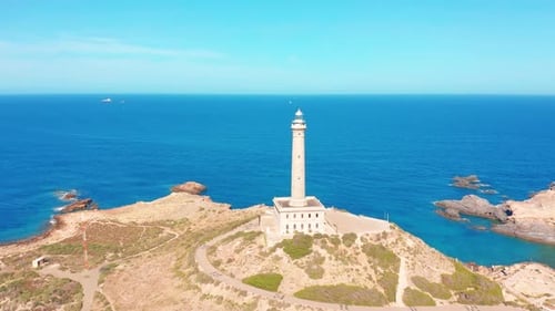 Aerial View of a Rock and a Lighthouse on the Sea