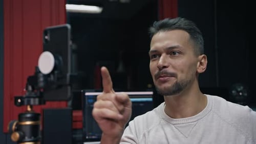 Young Adult Man Recording a Vlog in Studio