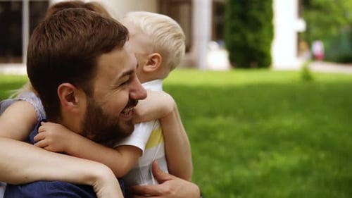Loving Family Embraces in a Green Park