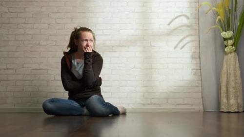 Distressed Woman Sitting Alone on Floor