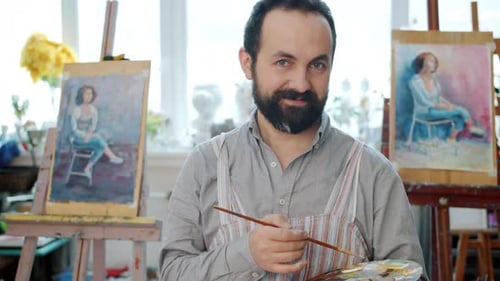 Portrait of Handsome Mature Man Holding Palette and Paintbrush in Arts Studio