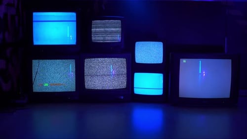 Vintage Televisions Displaying Static and Old Games