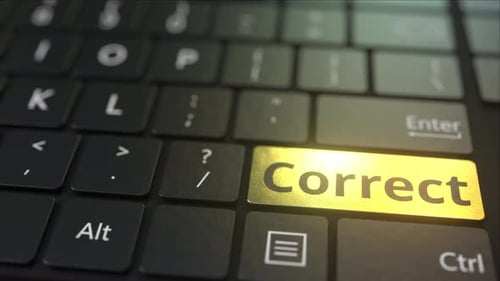 Black Computer Keyboard and Gold Correct Key