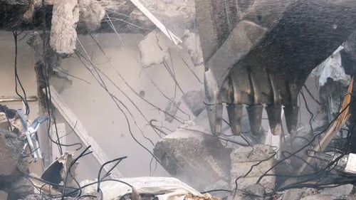 Excavator Demolishes Building with Water Spray