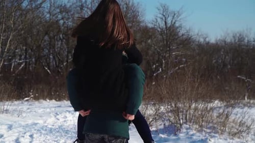 Happy Couple Having Fun in Winter Forest