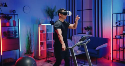 Man Using VR Headset While Walking on Treadmill