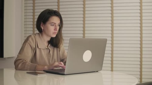 In the Evening Creative Woman Works on Laptop
