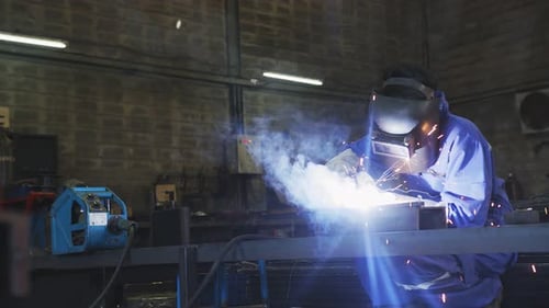 Welder Working on Steel with Protective Gear