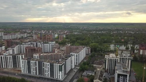 Aerial view of tall residential apartment buildings under construction in a city.
