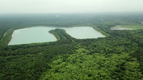Aerial Drone Footage Flying Forward Over Lakes and Forest