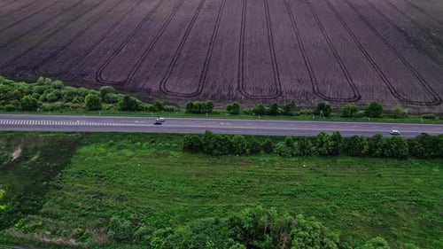 Aerial Road Cars Moving in the Green Fields of Summer