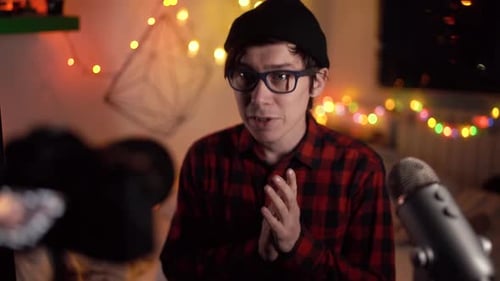 Young Adult Speaks into Camera with Microphone