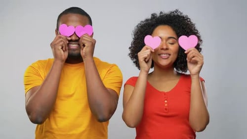 Affectionate Couple Holding Hearts and Touching Noses