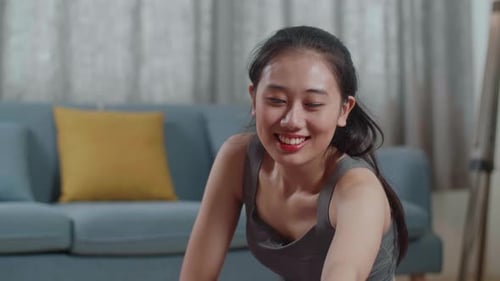 Smiling Woman Doing Yoga Stretch at Home