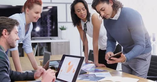 Business Team Reviews Data at Conference Table