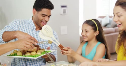 Smiling Family Sharing Celebration Meal at Home