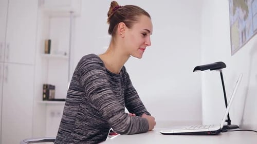 Happy Smiling Woman with Laptop Computer Having Video Conference at Home or Office