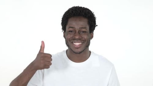 Smiling Young Man Gives a Thumbs Up
