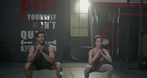 Two Muscular young Caucasian man and Asian woman doing laughing exercise workout