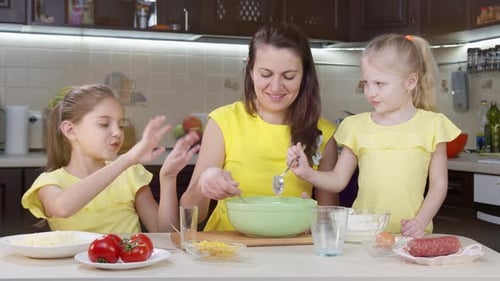 Close Up of a Cook Mixing Flour for Dough. A Child's Hand Pours Flour Into a Salad Bowl To Make