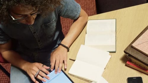 Young Adult Using Tablet at Desk