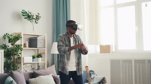Young Man Experiencing Virtual Reality in Living Room