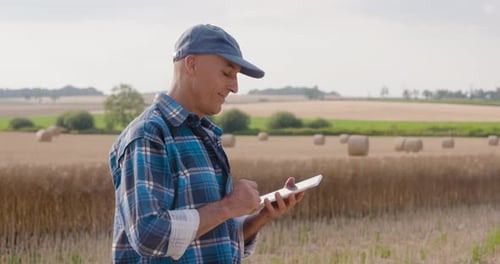 Farmer Using Tablet in Golden Wheat Field
