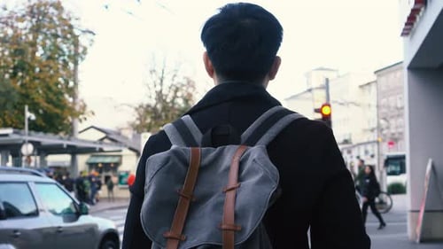 Young Asian Male Tourist Walking in City Centre in Europe