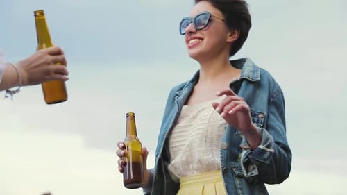 Beautiful Woman Drinking Beer And Dancing At Party Outdoors