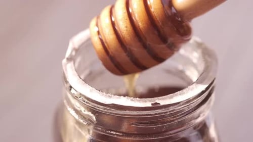 Fresh Honey with Spoon on Table