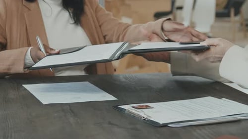 Woman Signing Job Offer in Workplace Environment