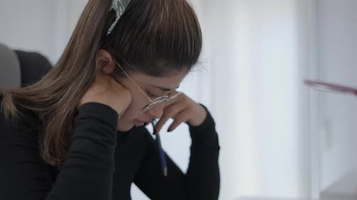 Colombian Young Female Student Writing Memo on Notebook Thinking Consider Plan