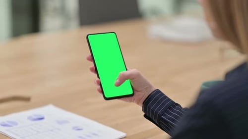 Rear View of Businesswoman Using Smartphone with Chroma Screen