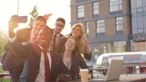 Business Team Poses for Selfie in Sunlight