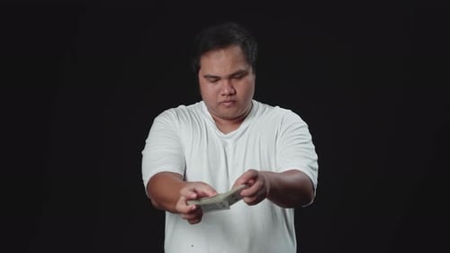 Person Shuffling Playing Cards Against Black Background