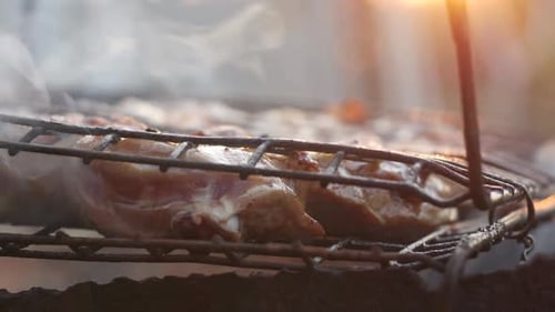 Close Up of Meat Grilling at Sunset