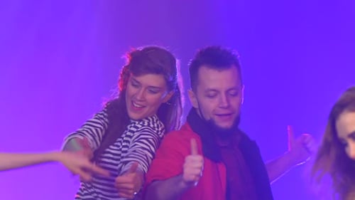 Friends Dancing at a Party Having a Night . Slow Motion . Smoke Background