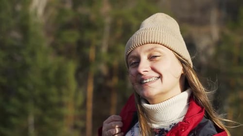 Caucasian Woman in Smiles and Braces are Visible on Her Teeth