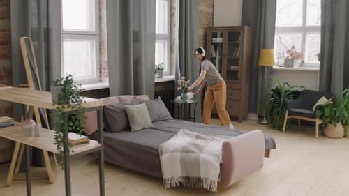 Woman Dancing While Cleaning Her Home