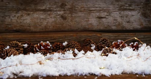 Pinecones, Snow, and String Lights for Christmas Background