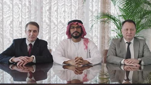 Men in Suits at Business Table Looking Forward