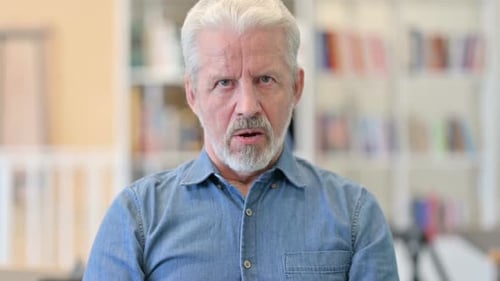 Man With Gray Hair Talking to Camera