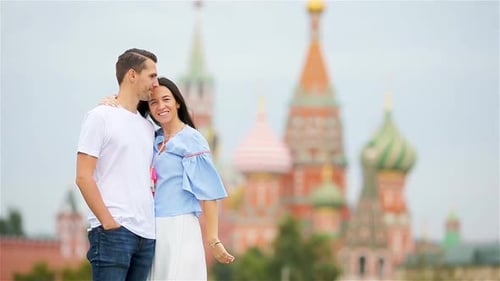 Young Dating Couple in Love Walking in City Background St Basils Church