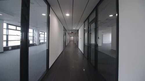 Motion Along Empty Corridor Between Offices in Building