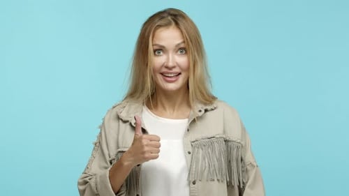 Close Up of Enthusiastic Blond Woman Approve Something Cool Showing Thumbs Up and Like Product Look